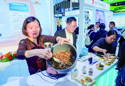 在南京医药展位，金陵药业推出的控糖五谷饭吸引众多观众品尝。 南京日报/紫金山新闻记者 戚珂嘉 摄 